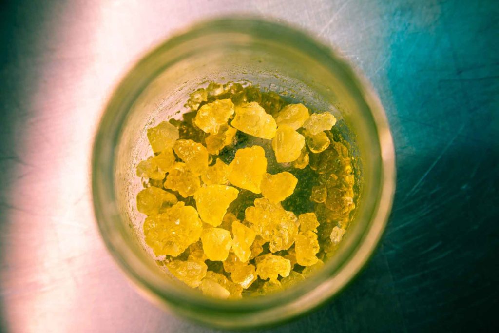 A glass full of yellow marijuana concentrate