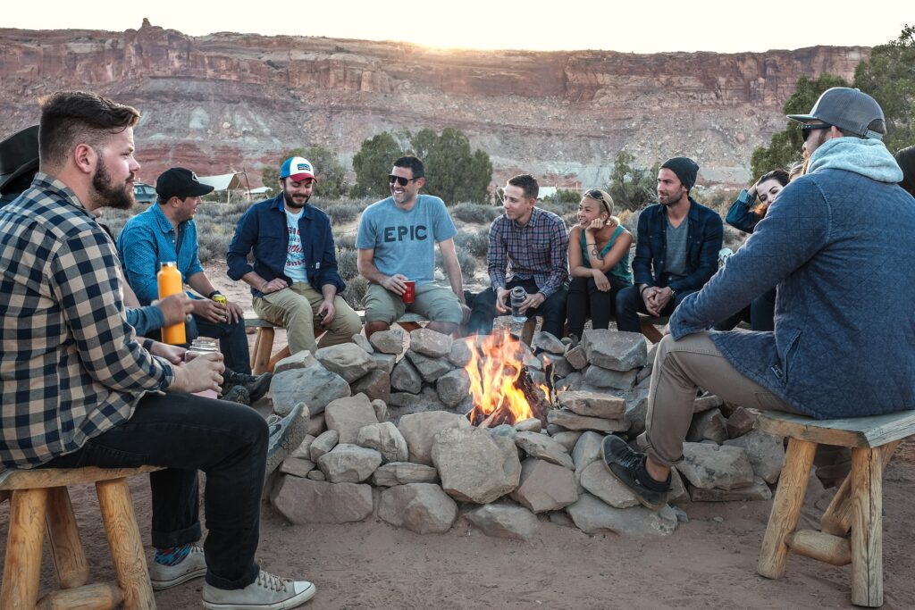  A group of men and women sitting around a campfire