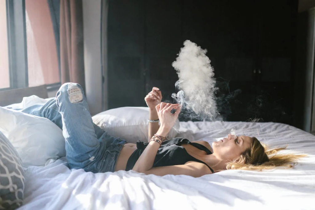  A woman lying on the bed and smoking weed