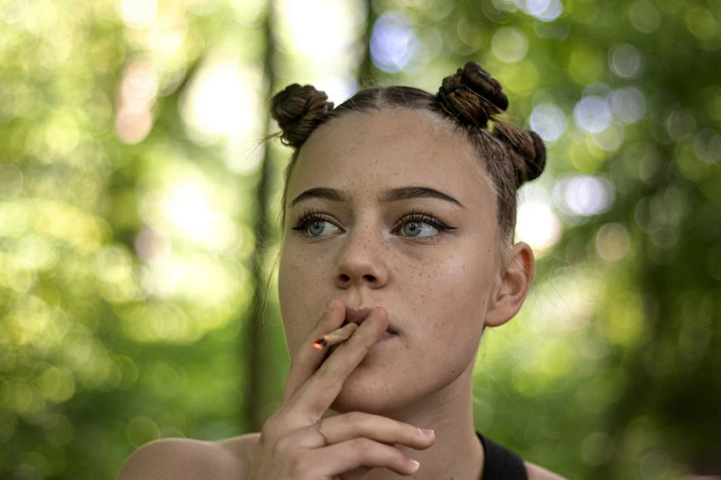 A young woman smoking weed outdoors