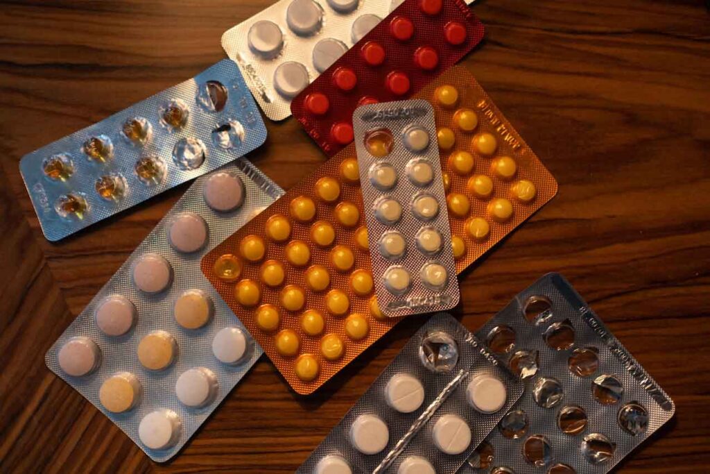 Medication blister packs on a wooden surface