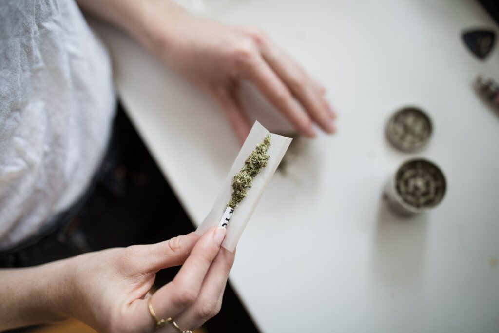 Woman rolling joint with filter